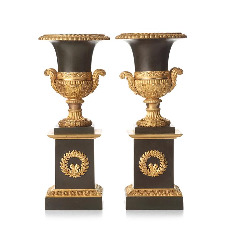 A pair of French Empire early 19th century gilt and patinated bronze urns.