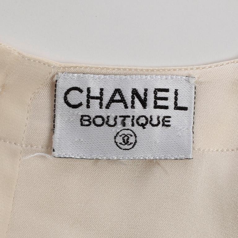 CHANEL, a white silk shirt.