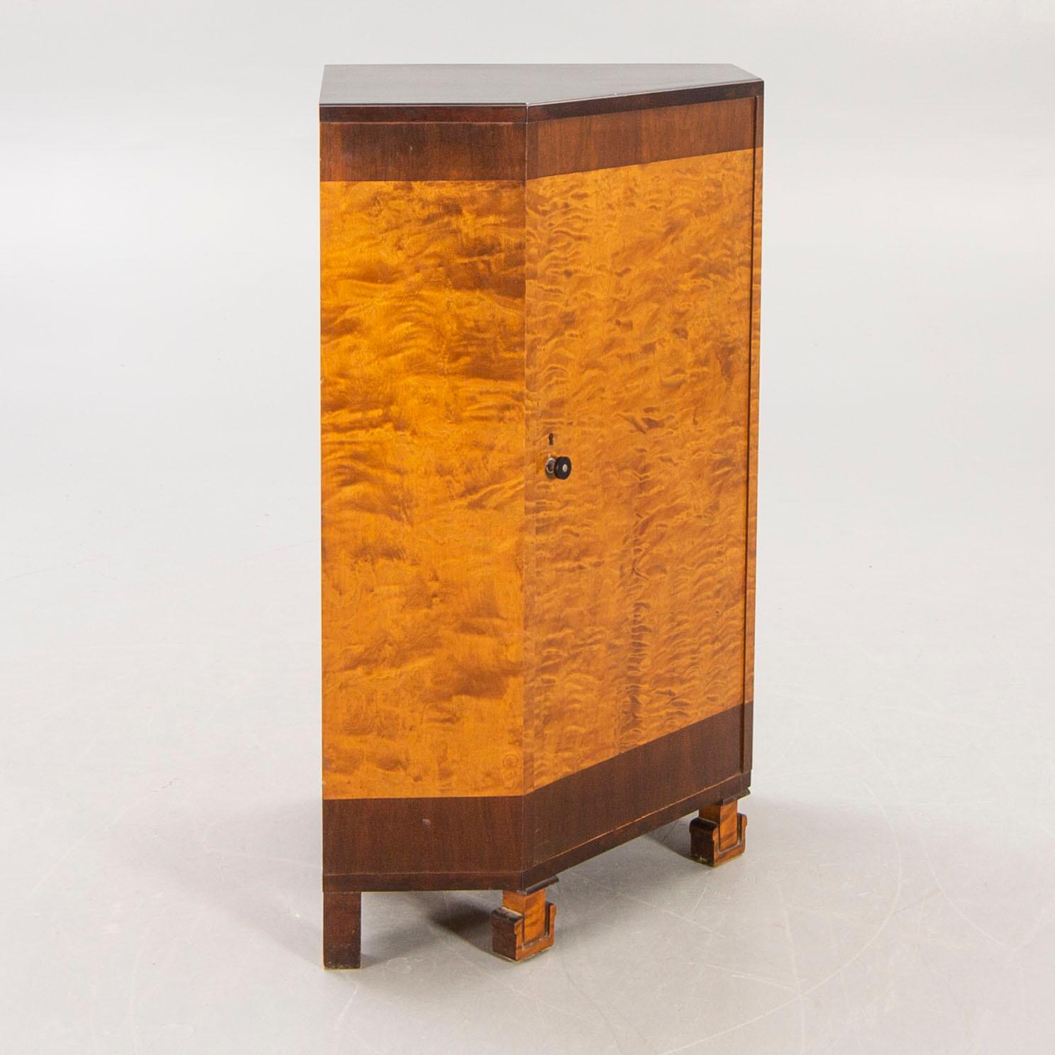 A 1930s birch corner cabinet.