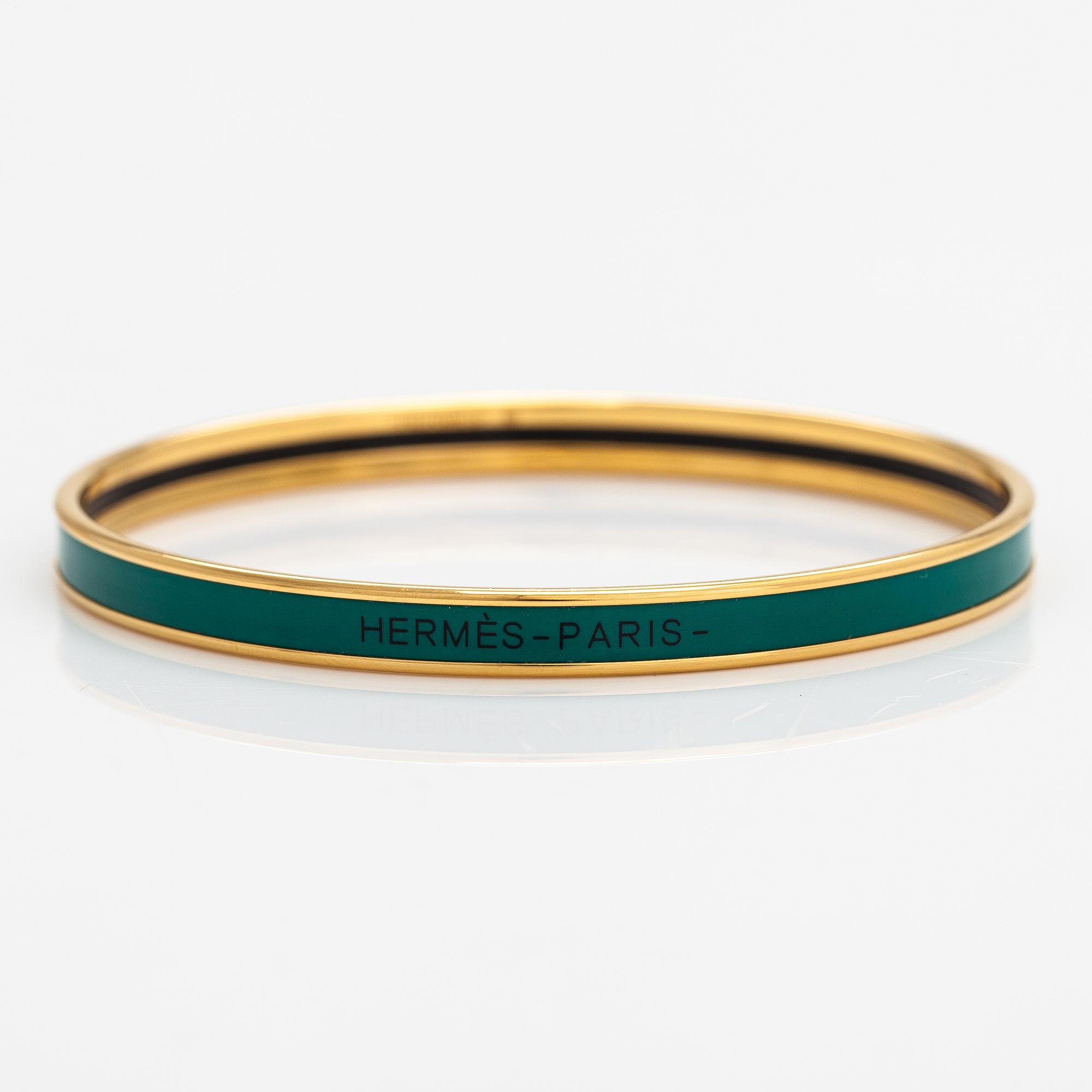 Hermès, a bracelet made of gold coloured metal and green enamel. Marked Hermès Paris, Made in France.