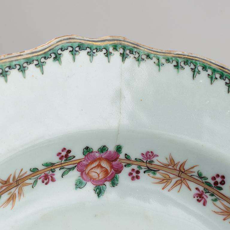 A pair of armorial dinner plates and a group of three odd famille rose plates, Qing dynasty, Qianlong (1736-95).