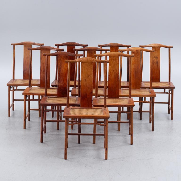 A Chinese hardwood dinner table and ten chairs with rattan seats, 20th century.