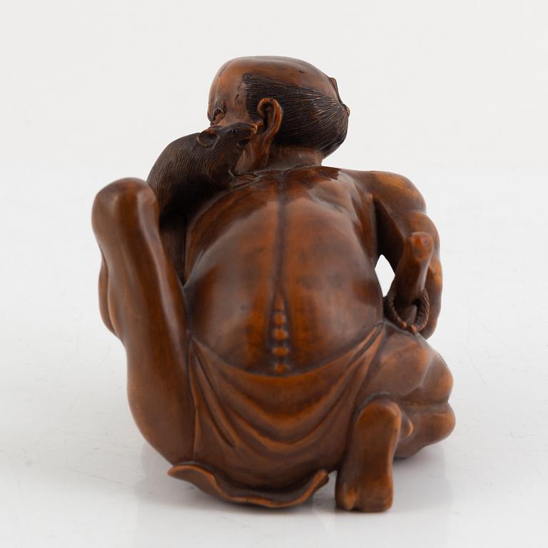 A Japanese mei boxwood okimono of a rat catcher. Meiji period.