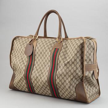 Gucci, a canvas weekend bag.