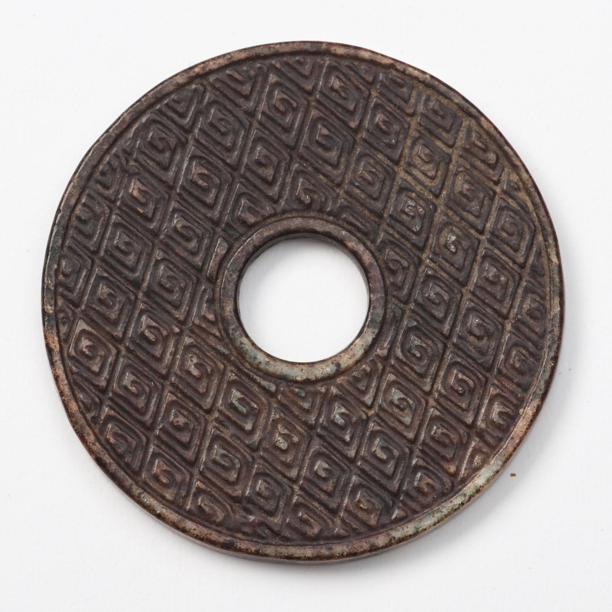 A group of three archaistic Chinese stone bi discs and two pendants.