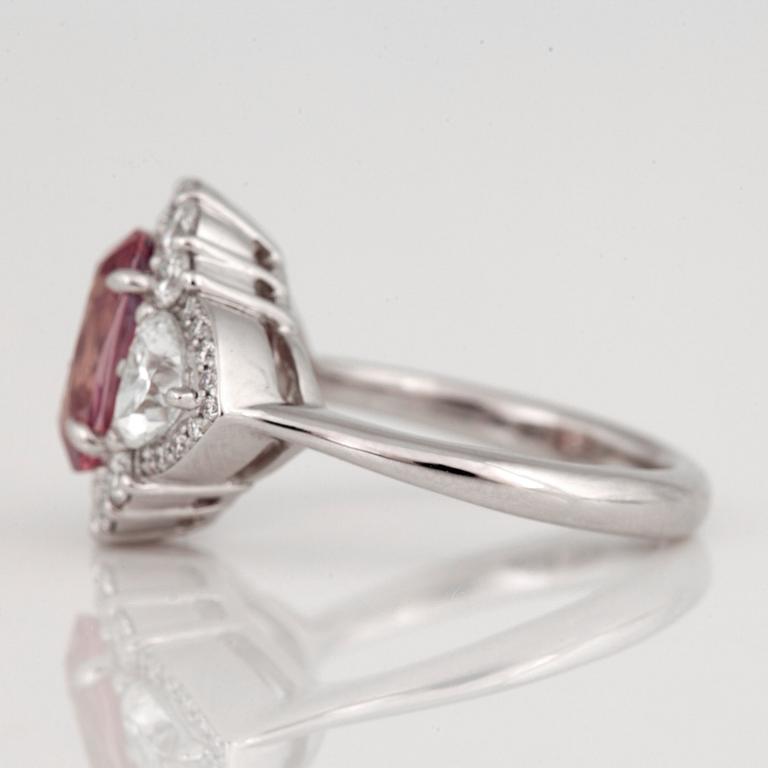 An untreated padparascha (orangy pink sapphire) and diamond ring.