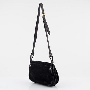 Céline, a black suede handbag.