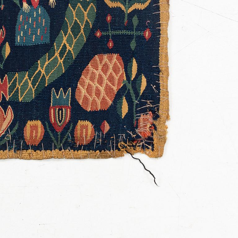 A carrige cushion, "Bebådelsen", tapestry weave, ca 95 x 47,5 cm, Skåne, 1800-1830.