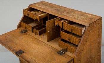 A carved oak secretaire, 19th Century.
