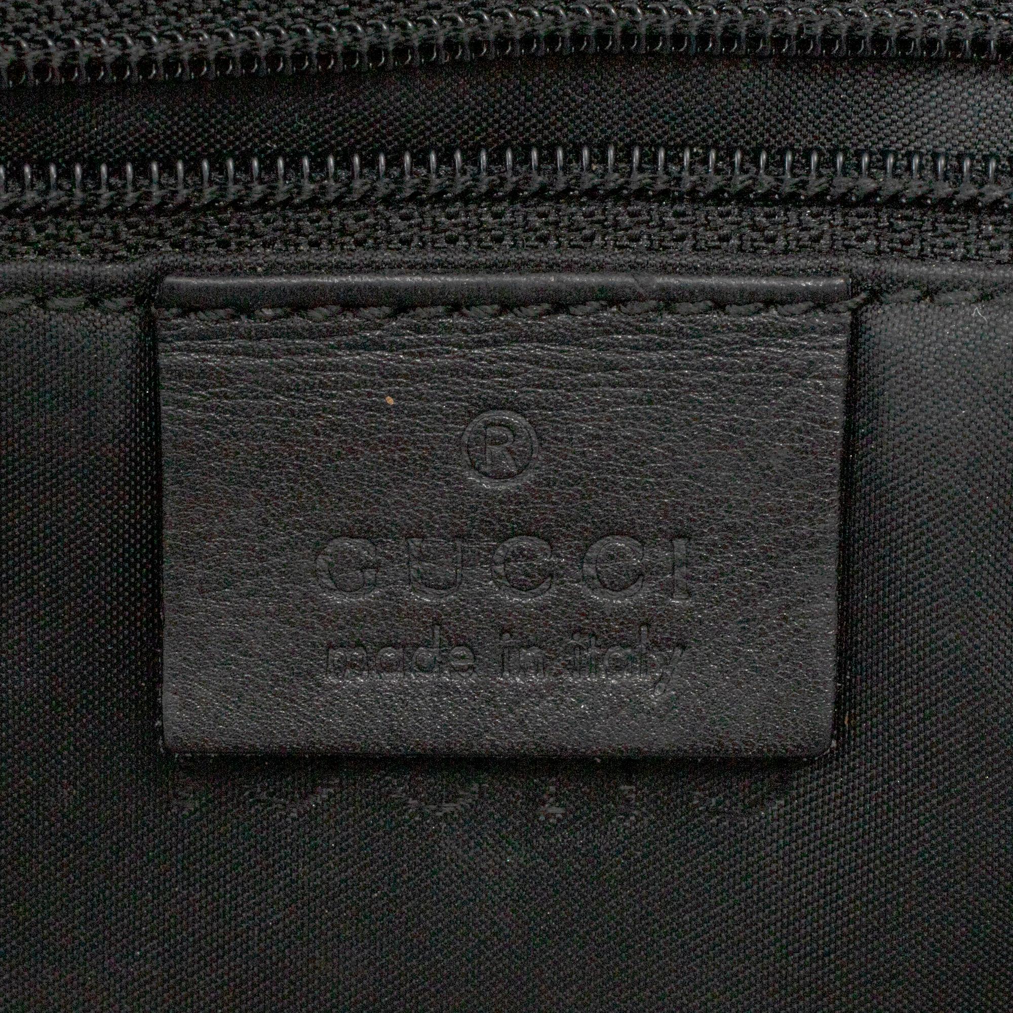 GUCCI, a canvas handbag.