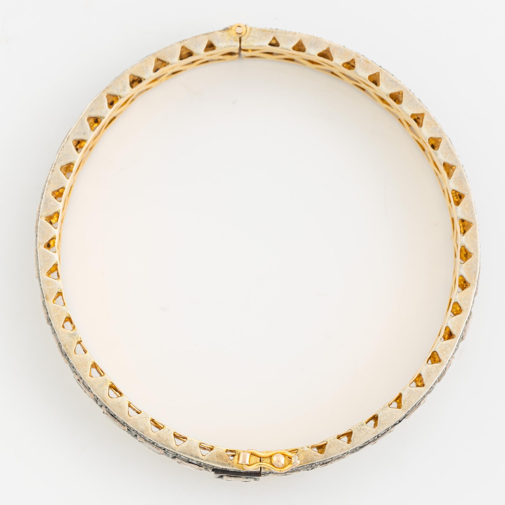 A faceted diamond bangle.