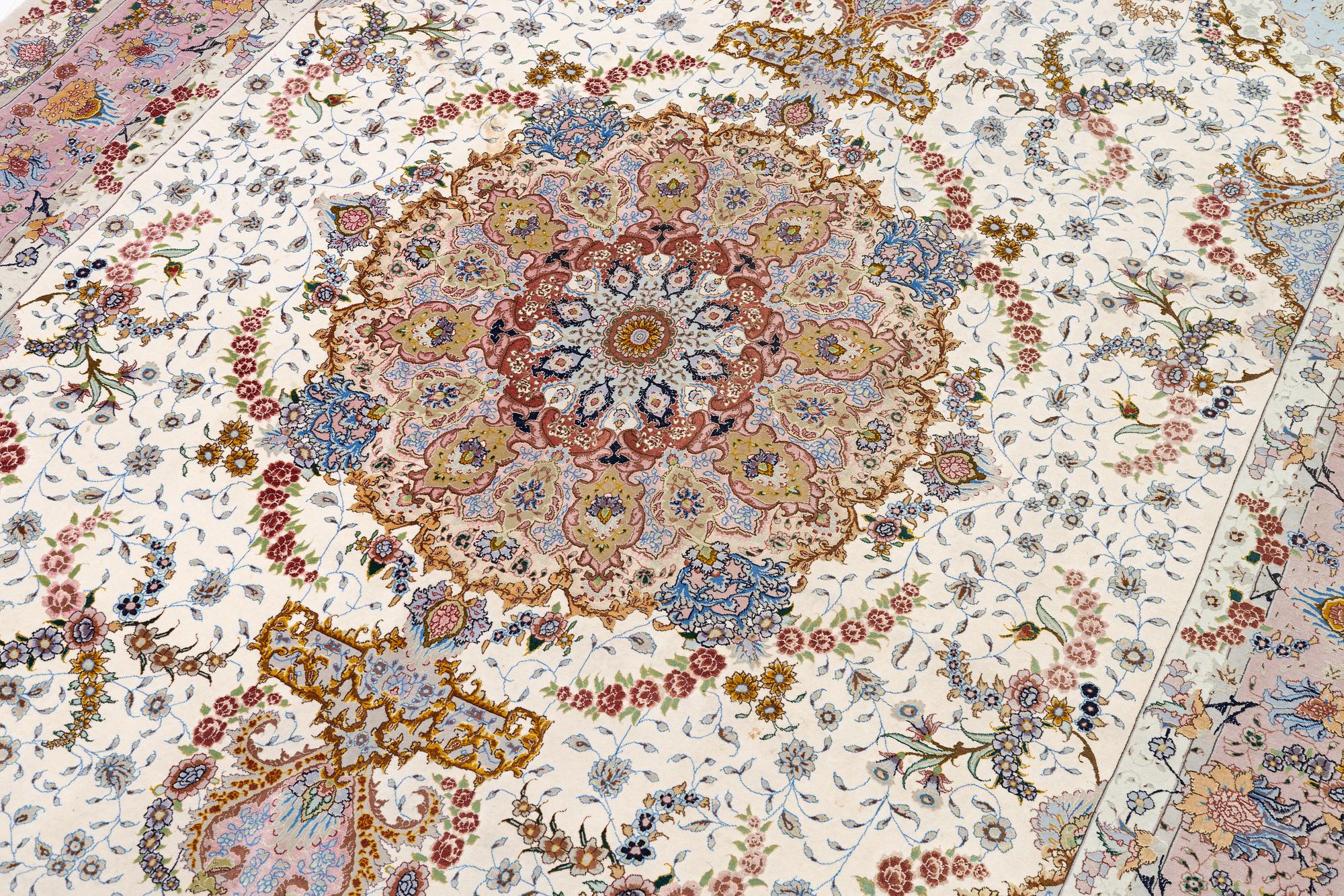 A Tabriz carpet north west Persia, part silk, c. 314 x 197 cm.