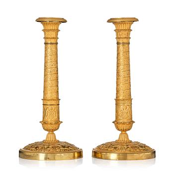 155. A pair of French Empire ormolu candlesticks, Paris, early 19th century.