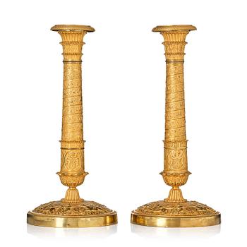 155. A pair of French Empire ormolu candlesticks, Paris, early 19th century.