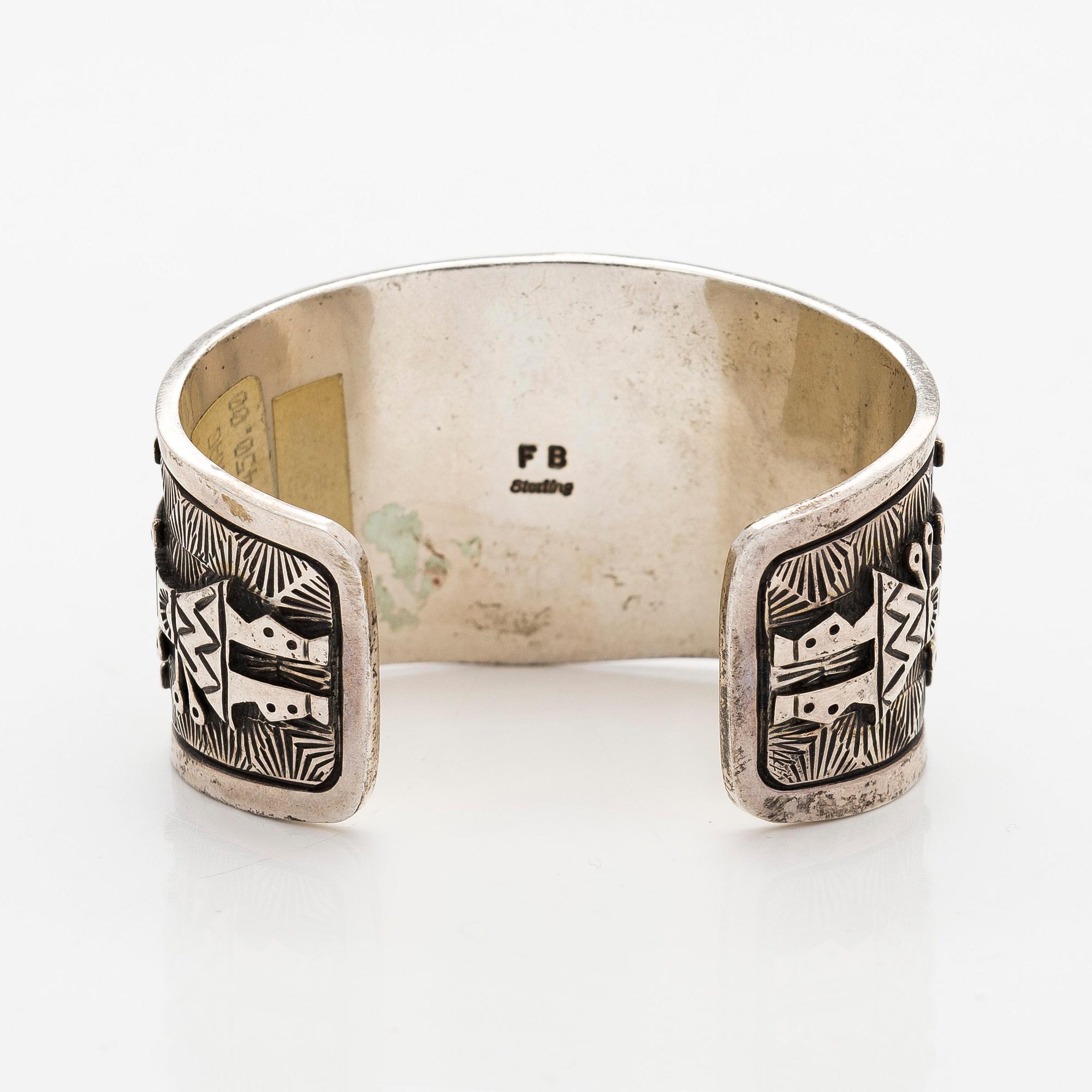 A silver bracelet with coral.