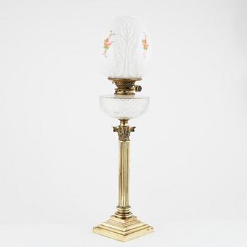 A brass and glass column shaped paraffin lamp, end of the 19th Century.