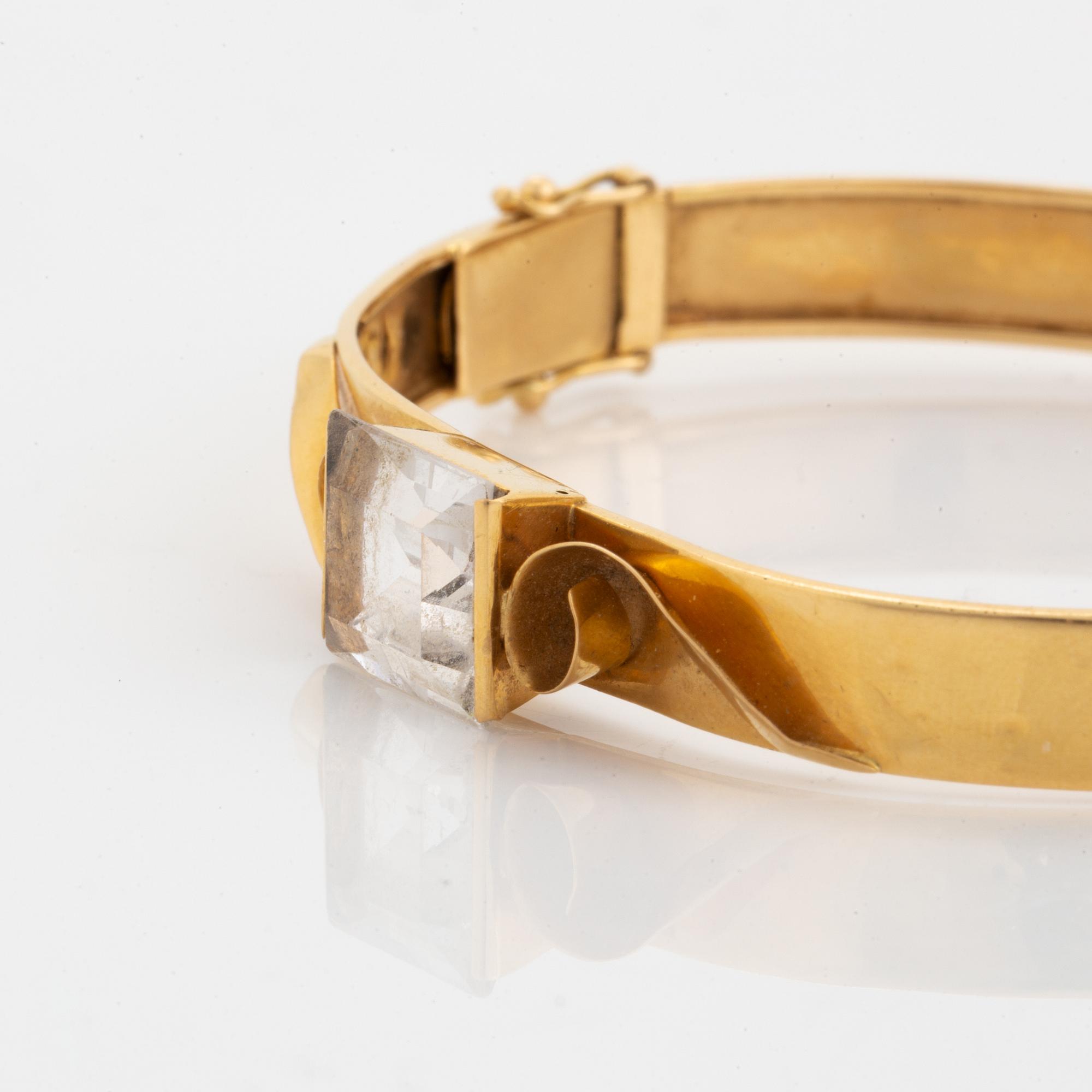 18K gold bangle and white synthetic stones.