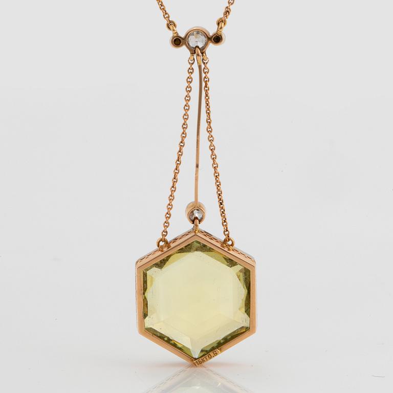 An 18K gold and platinum pendant set with a faceted beryl, old-cut diamonds and pearls.