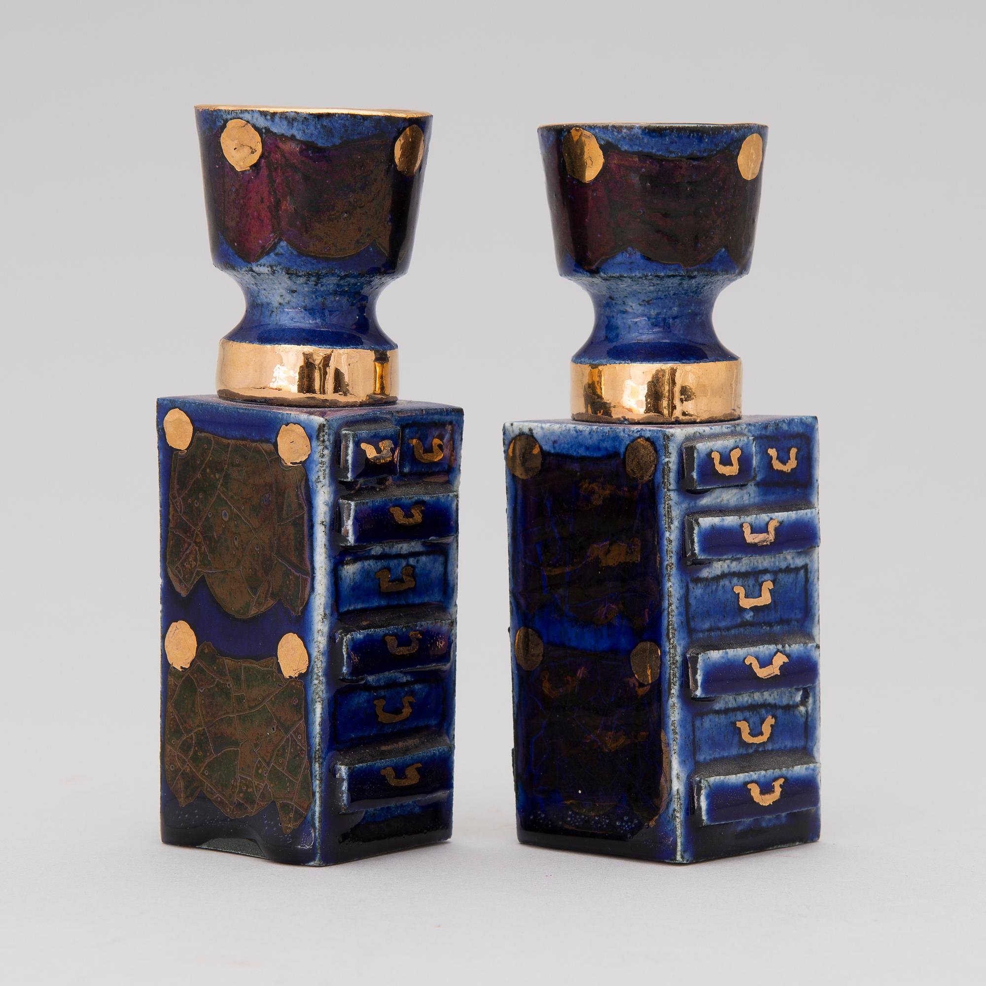 A pair of ceramic candlesticks signed Kaipiainen.