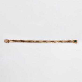 A 14K gold bracelet with a green glass stone. Finnish import marks 1966.