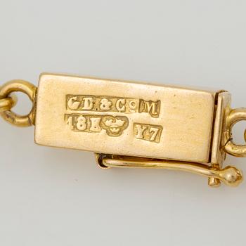 Bracelet in 14K gold with various minerals and scarab-shaped charms.