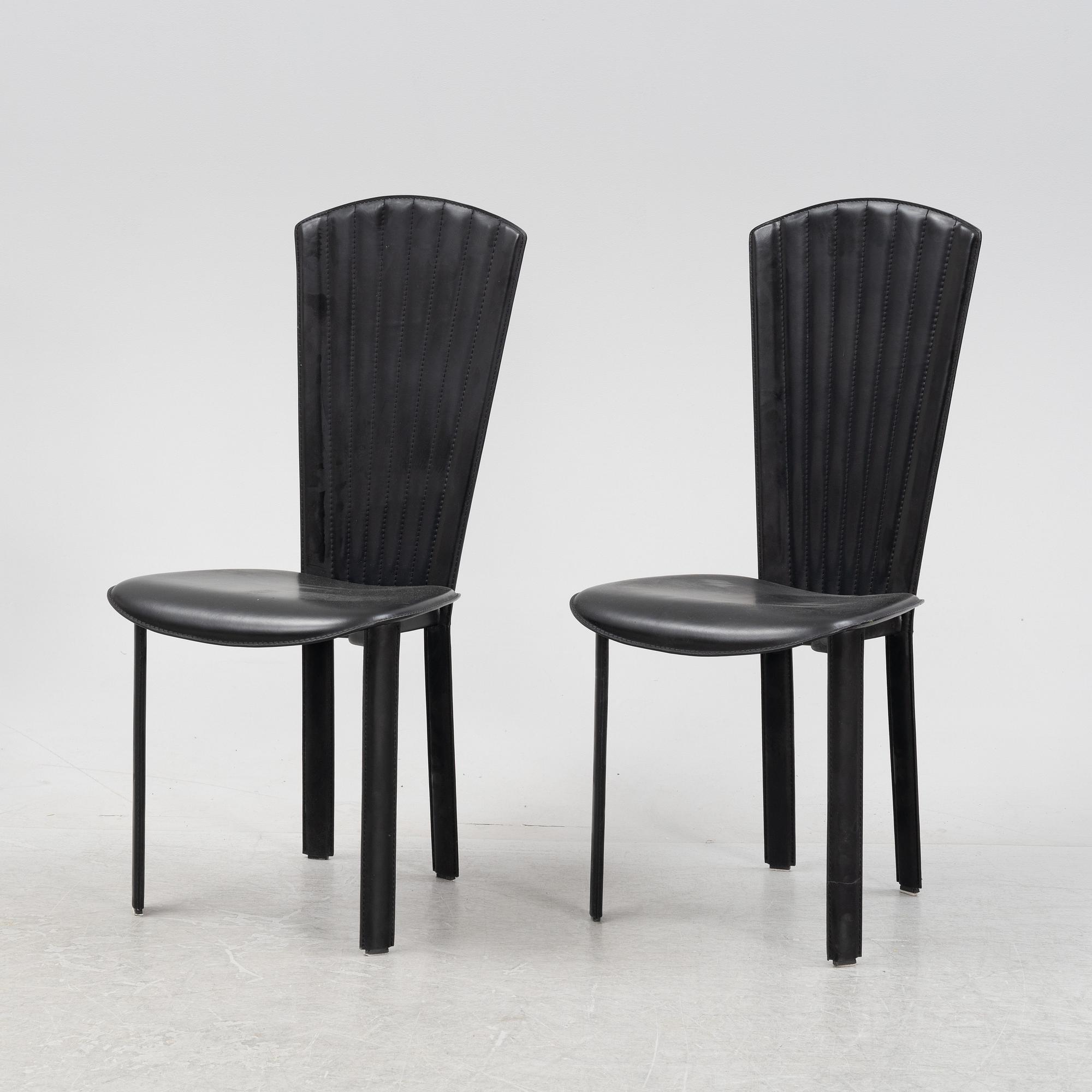 Twelve black leather 'Sossano' chairs, Quia, Italy.
