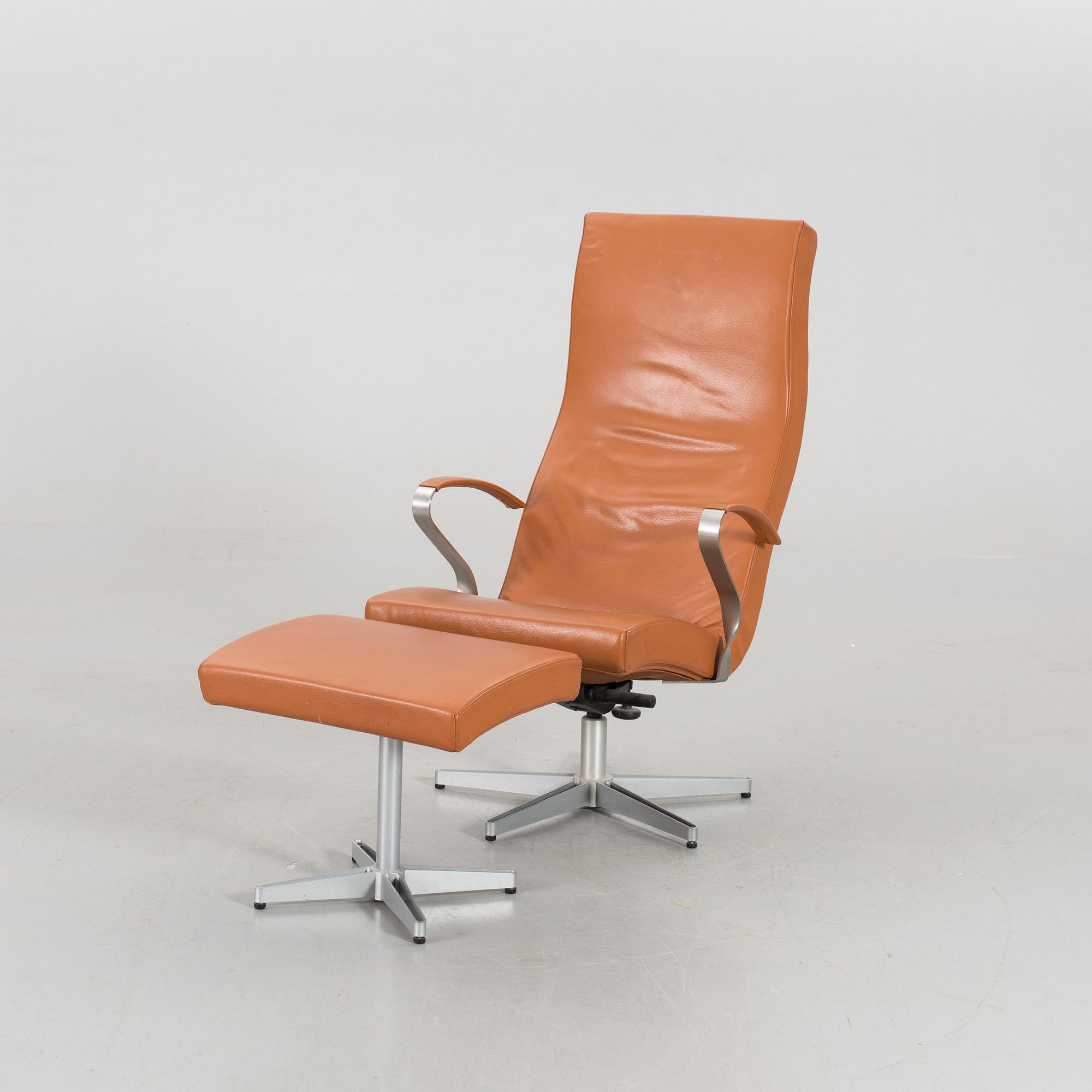 AN ARMCHAIR WITH STOOL MODEL "TWIST" DESIGNED BY JERKER ANDERSSON FOR SÖDERBERGS MÖBLER.