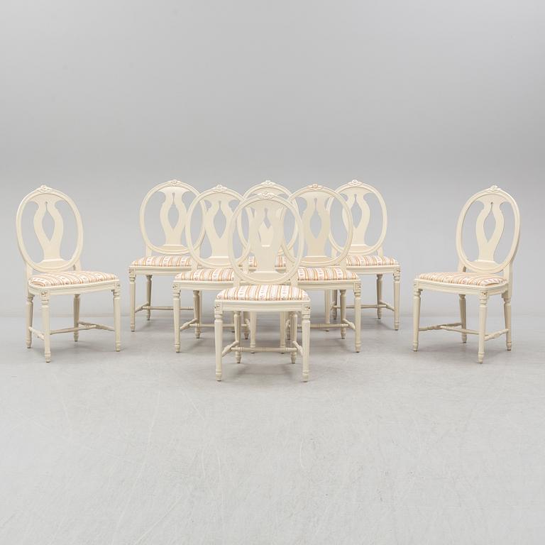 A set of eight chairs and a dining table. Gustavian style, second half of the 20th century. 2 leaves included.