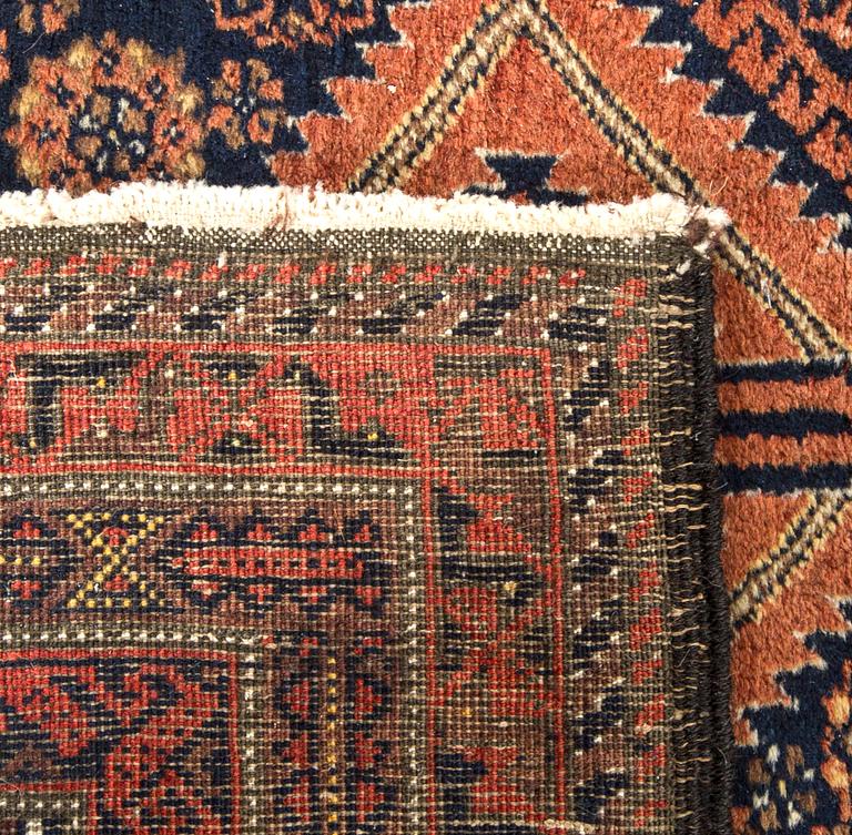 An antique Beludj carpet ca 227 x 122 cm.