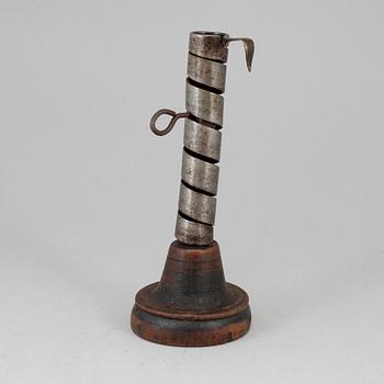 An 18th century wood and iron candlestick.