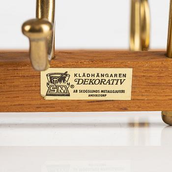 A pair of 'Dekorativ' teak coat hangers, Skoglunds metallgjuteri, Anderstorp, 1950's/60's.