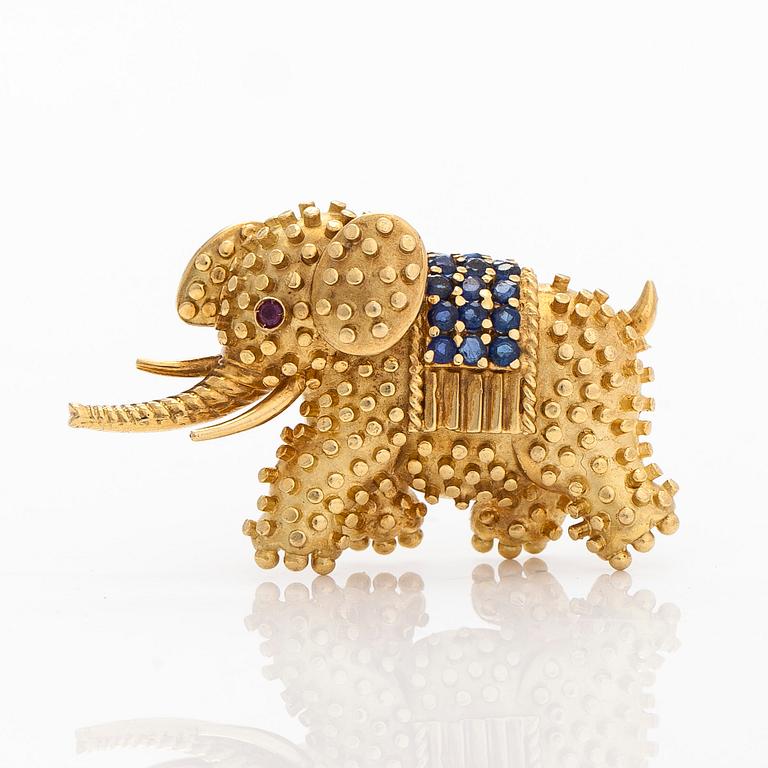 Tiffany & Co, an 18K gold elephant brooch, set with sapphires and rubies.