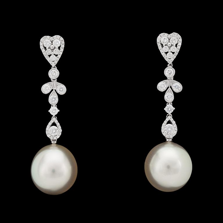 A pair of cultured south sea pearls, 12,2 mm, and brilliant cut diamond earrings, tot. 1.70 cts.