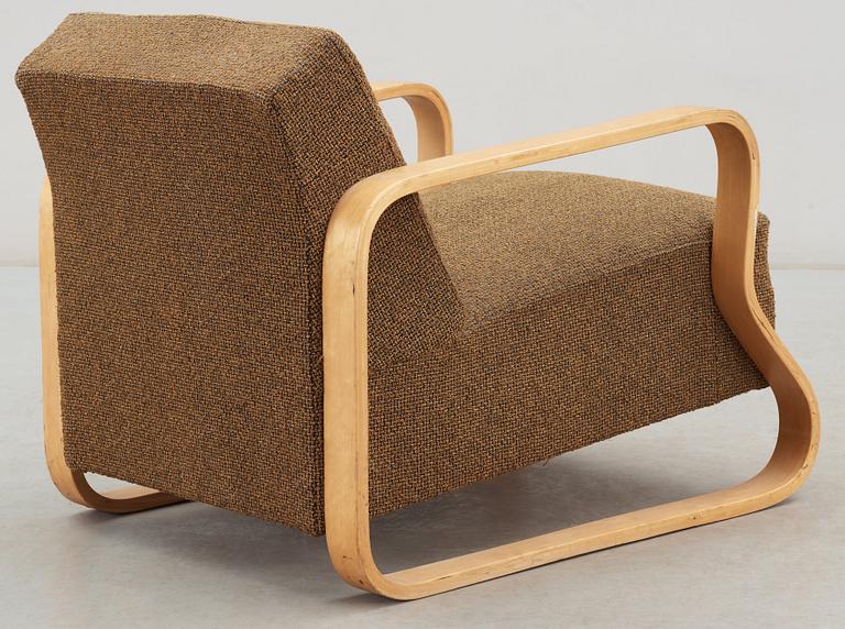 An Alvar Aalto laminated birch 'padded Paimio chair', upholstered in yellow and black fabric.