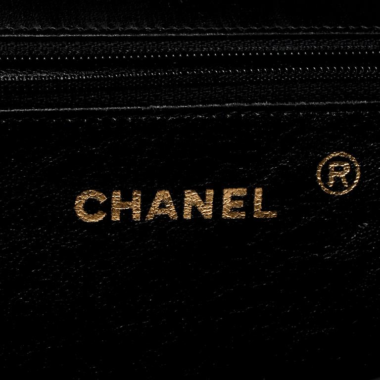 CHANEL, a black patent leather flap bag.