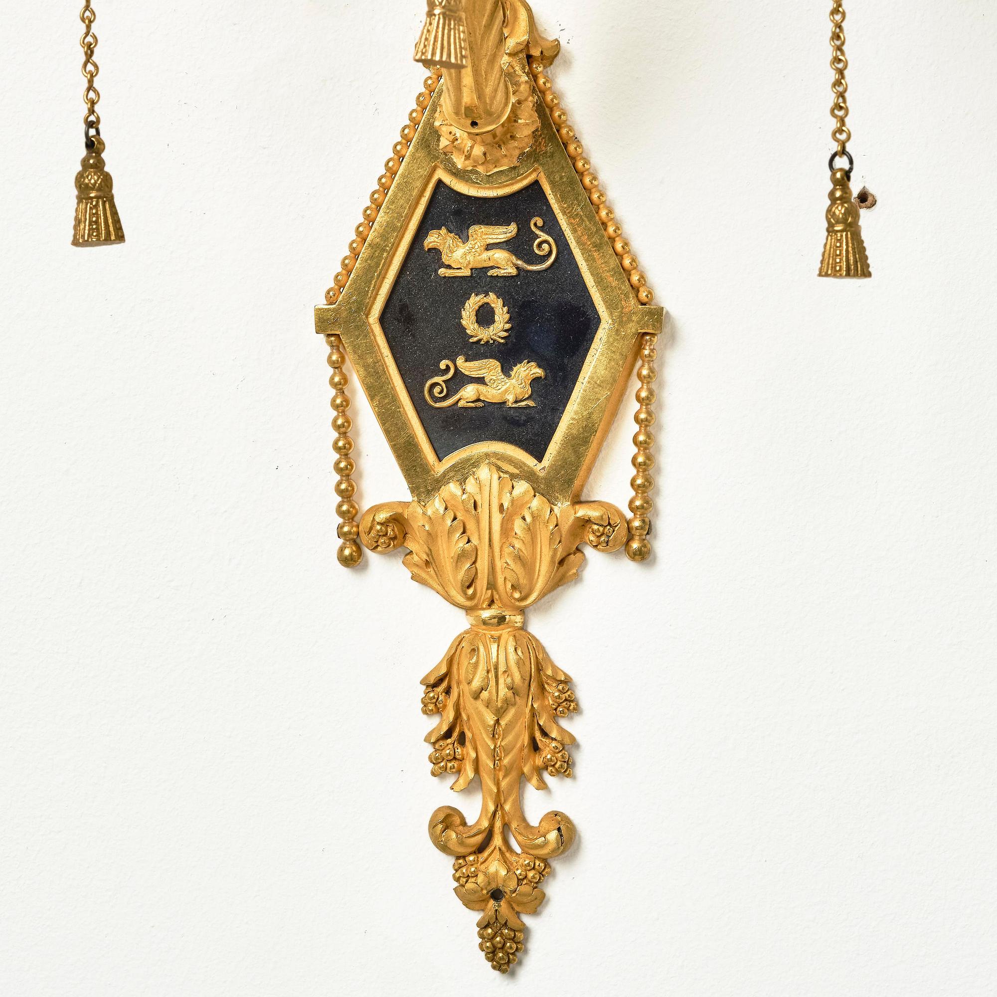 A pair of two-branch late Louis XVI ormolu and blued steel appliques attr. to F. Rémond (bronzier in Paris 1774-1812).