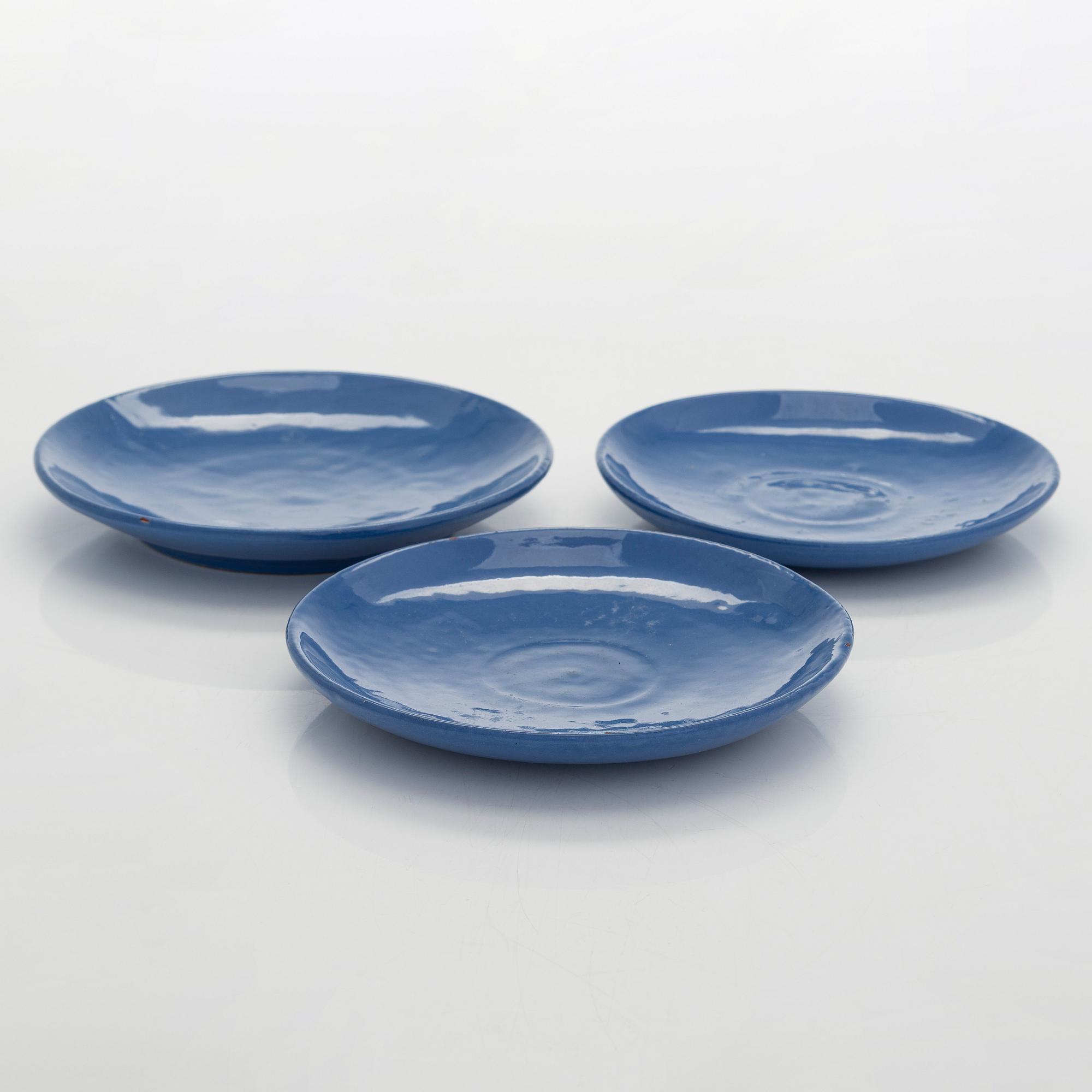 Marita Lybeck, a set of three ceramic plates and cream jug, red clay, signed ML.