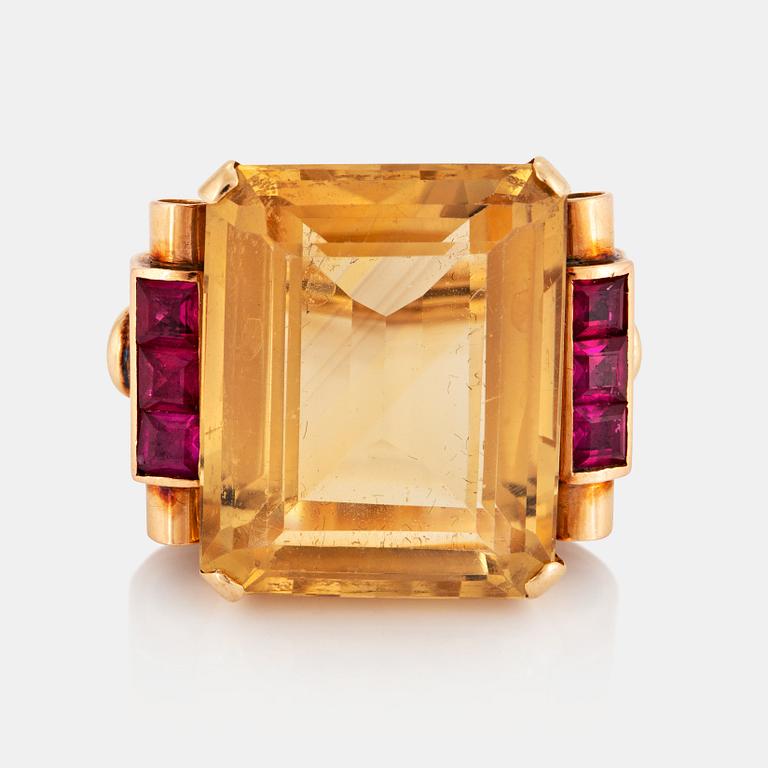 A 14K gold ring set with a faceted citrine and rubies.