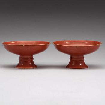 A pair of red glazed tazzas, Qing dynasty with Qianlong sealmark in underglaze blue.