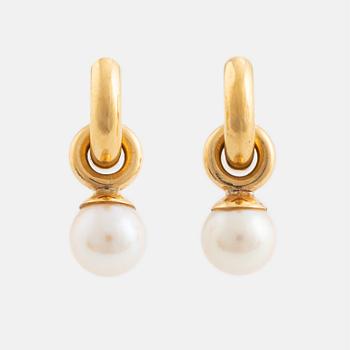 A pair of gold earrings with pearls.