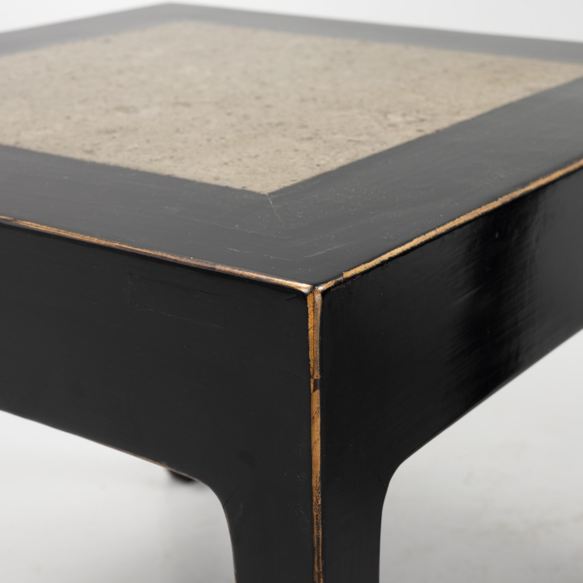 A pair of blac painted side tables with stone tops.