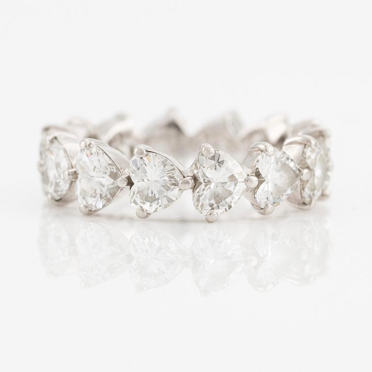 A Graff platinum eternity band set with heart shaped diamonds.