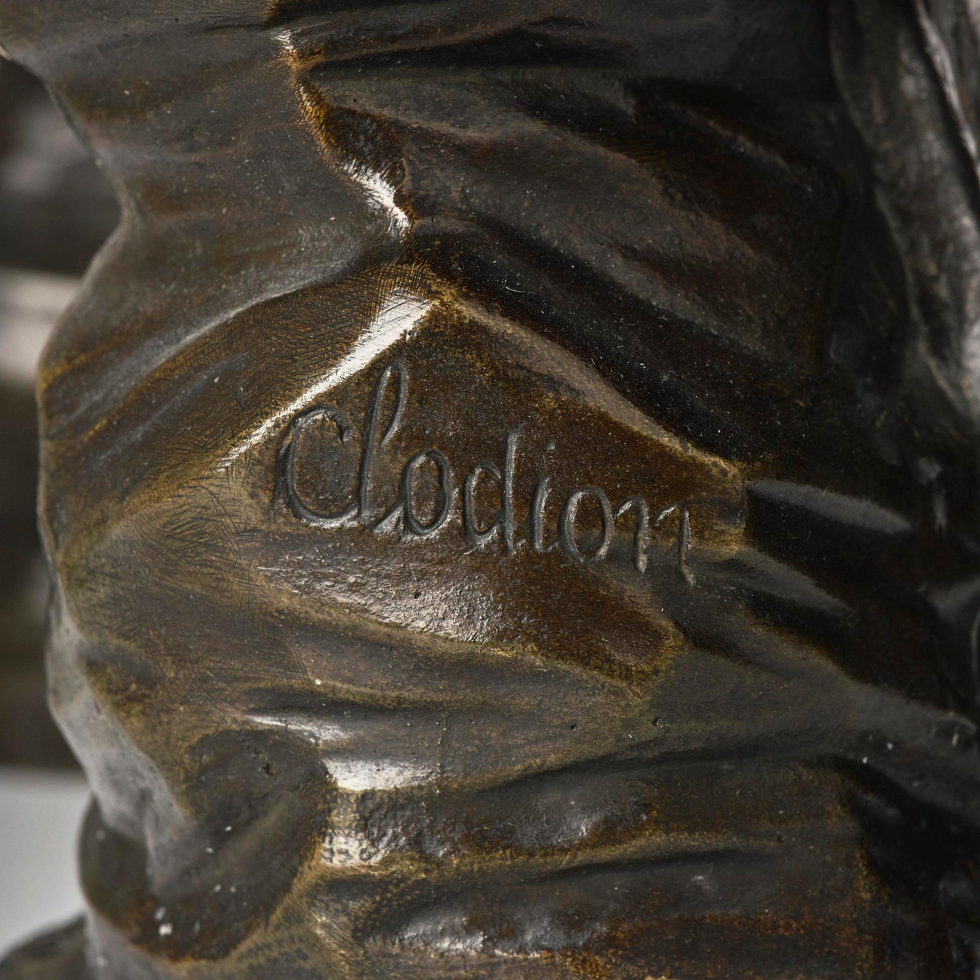 A pair of Louis XVI-style four-light gilt and patinated bronze candelabra after Clodion, later part 18th century.