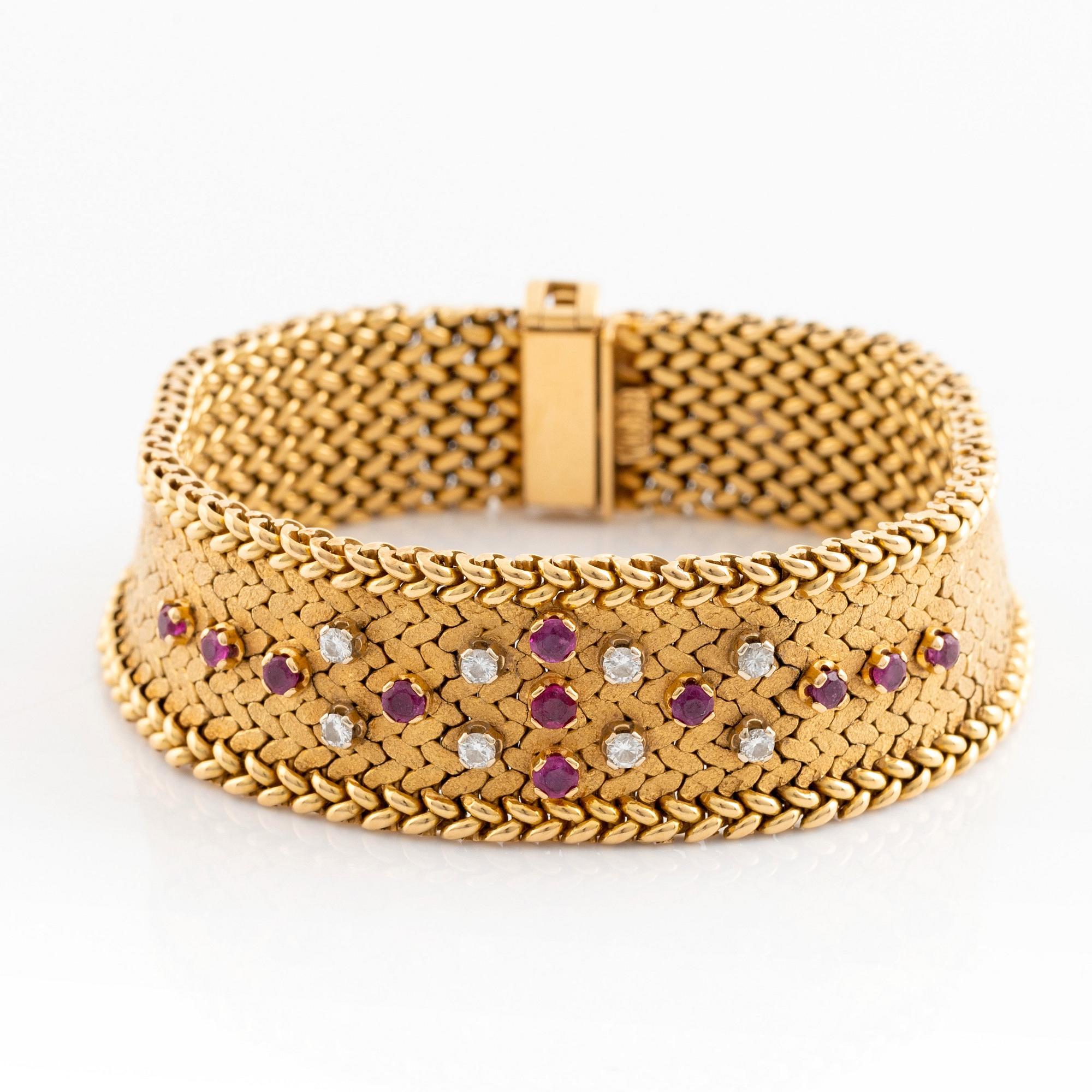An 18K gold bracelet set with round brilliant-cut diamonds and rubies.