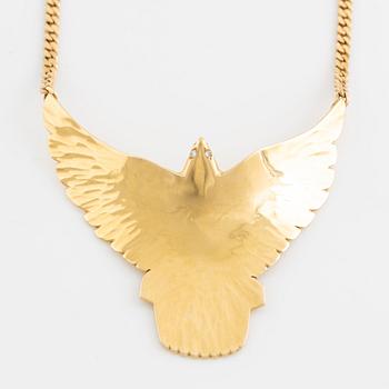 Gold and brilliant cut diamond bird necklace.