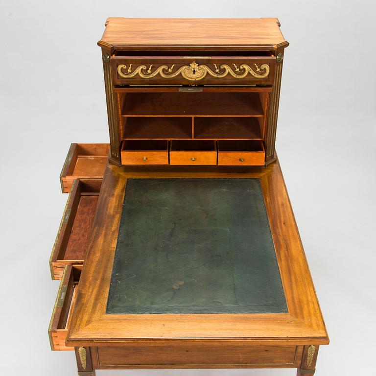 A 20th-century Louis XVI style mahogany veneered writing desk.
