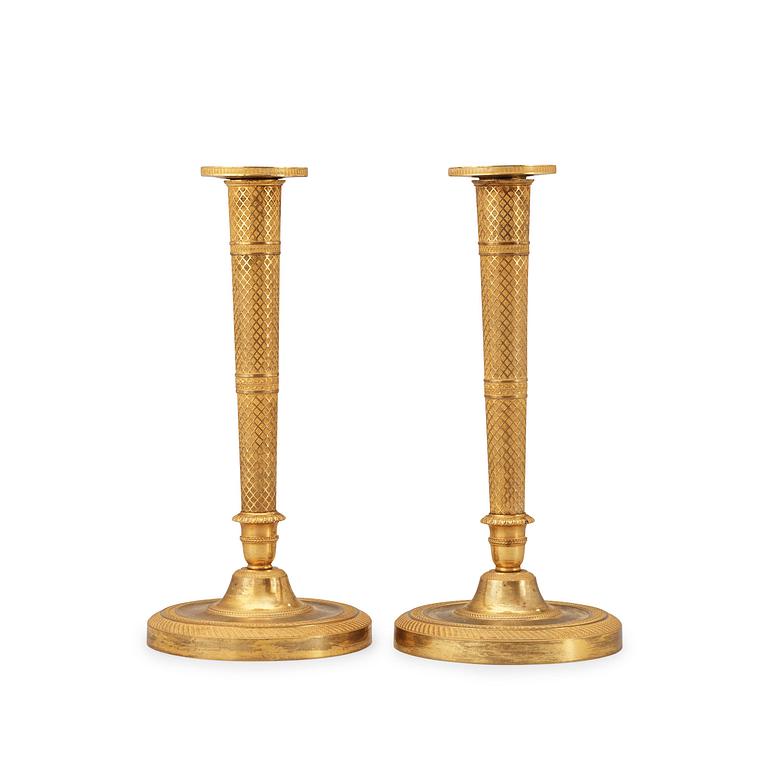 A pair of French Empire early 19th century candlesticks.