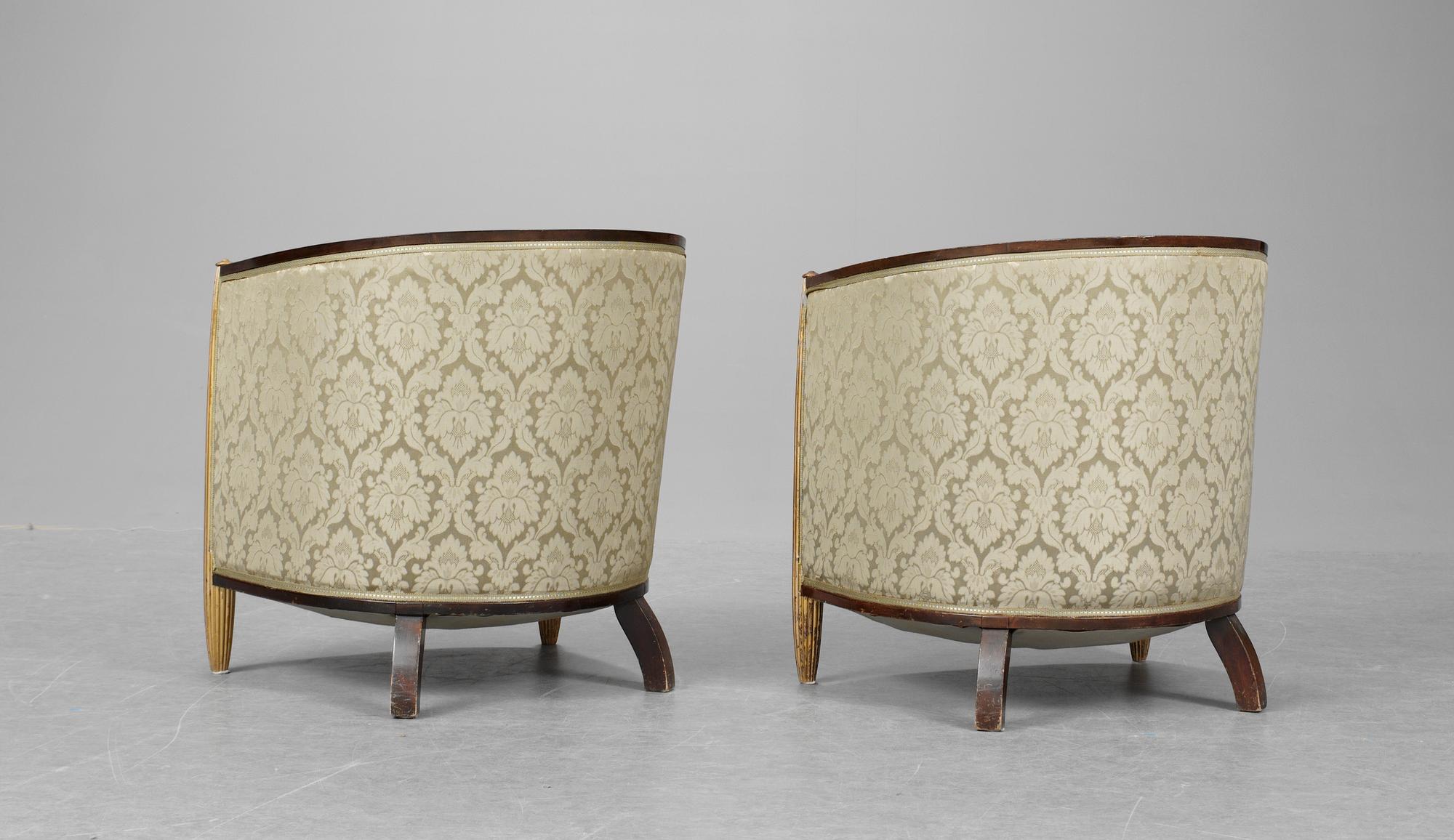 A pair of French partly gilt palisander armchairs in the manner of Poul Follot, 1920-30's.