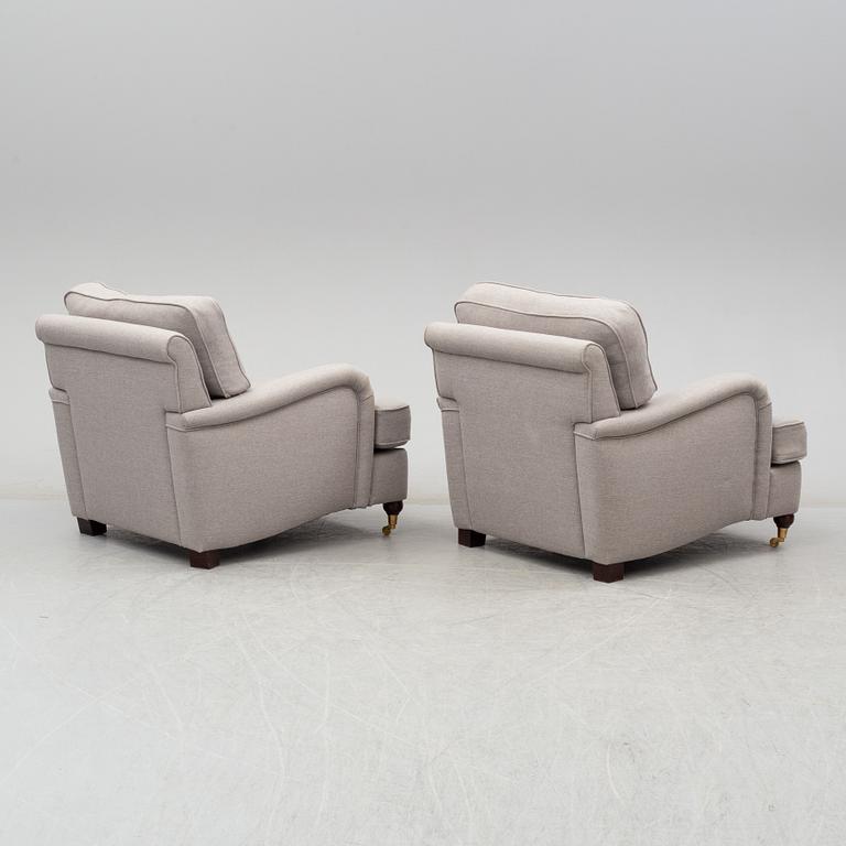 A 21st Century pair of Howard lounge chairs.