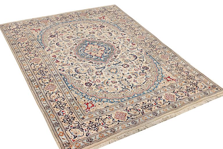 A Nain carpet, part silk, 9 laa, c. 300 x 195 cm.